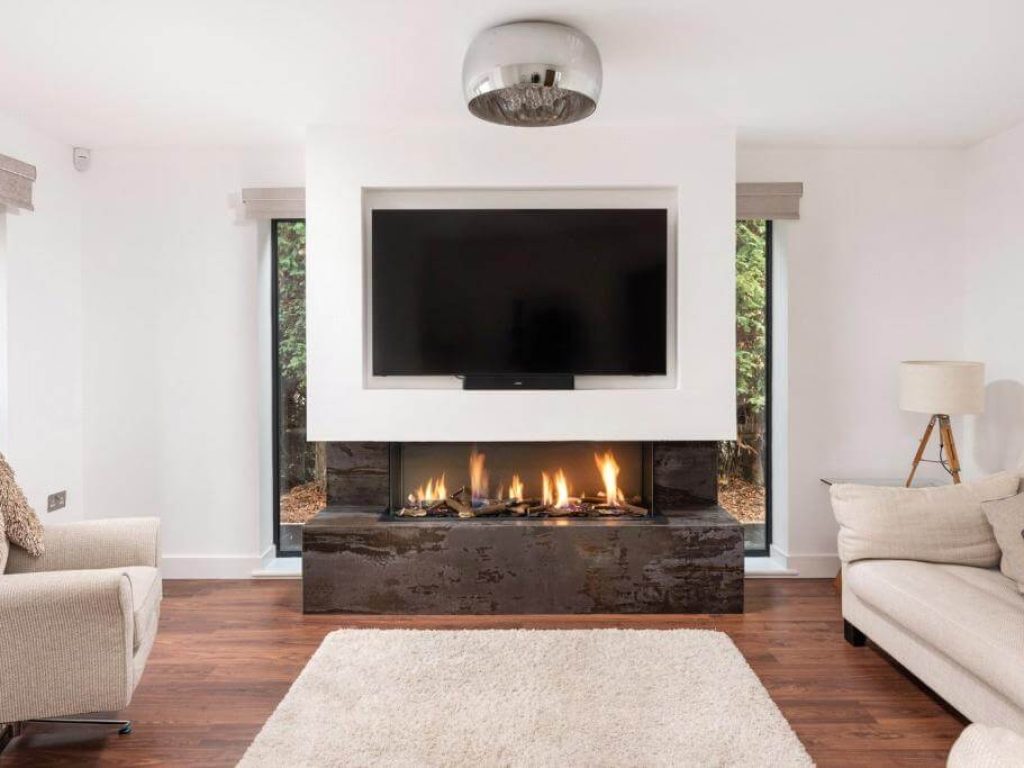 Media Wall Featuring the DRU Metro 130XT Luxury 3-Sided Gas Fire & Dekton Trillium Base