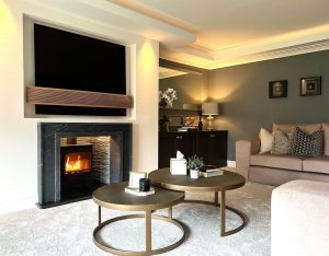 media wall featuring a classic wood-burning stove and bespoke slate fireplace surround